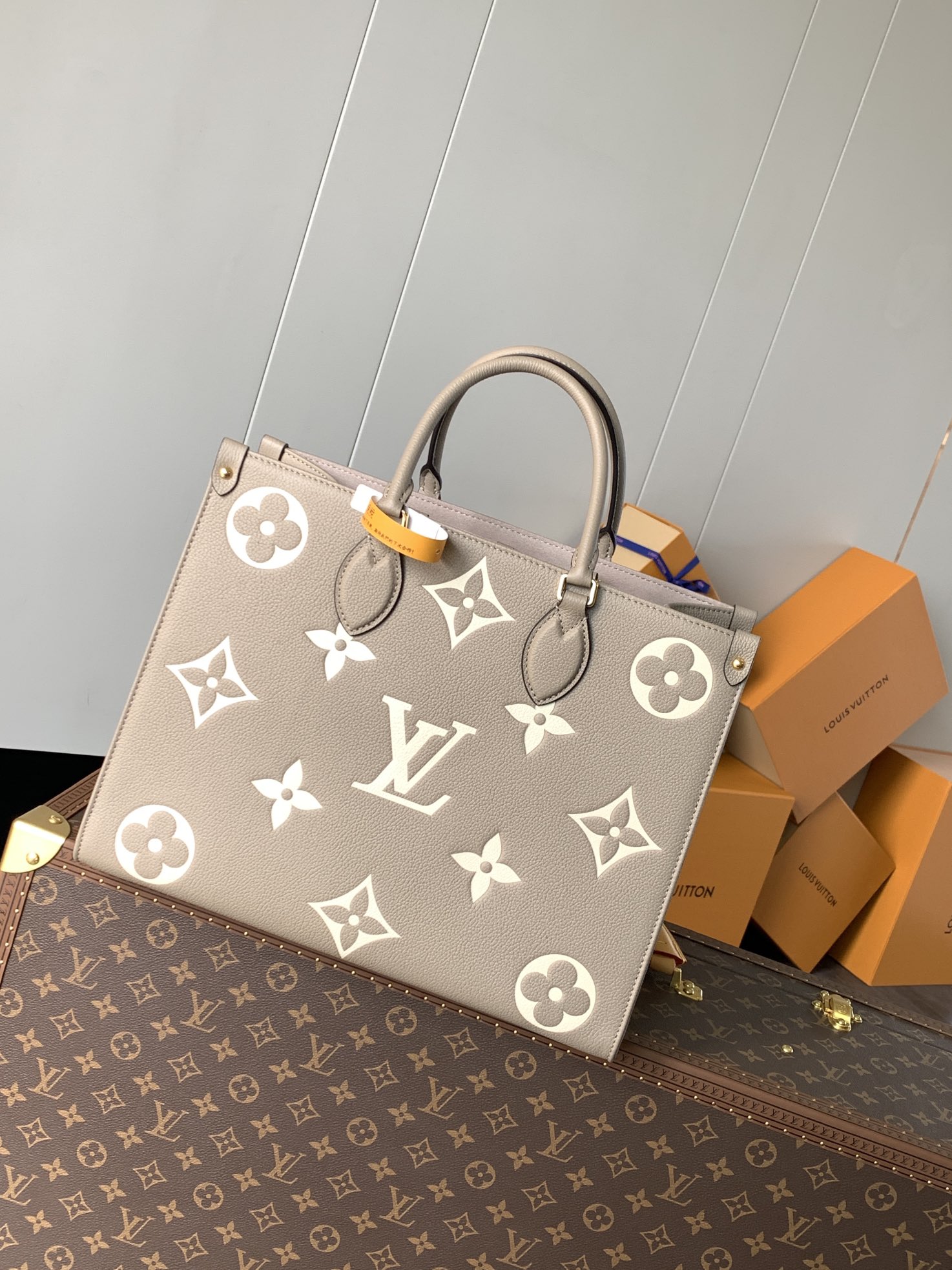 Variable Code Chip LV M45494 apricot printing OnTheGo medium handbag. Monogram Empreinte leather. Rolled leather handle and long